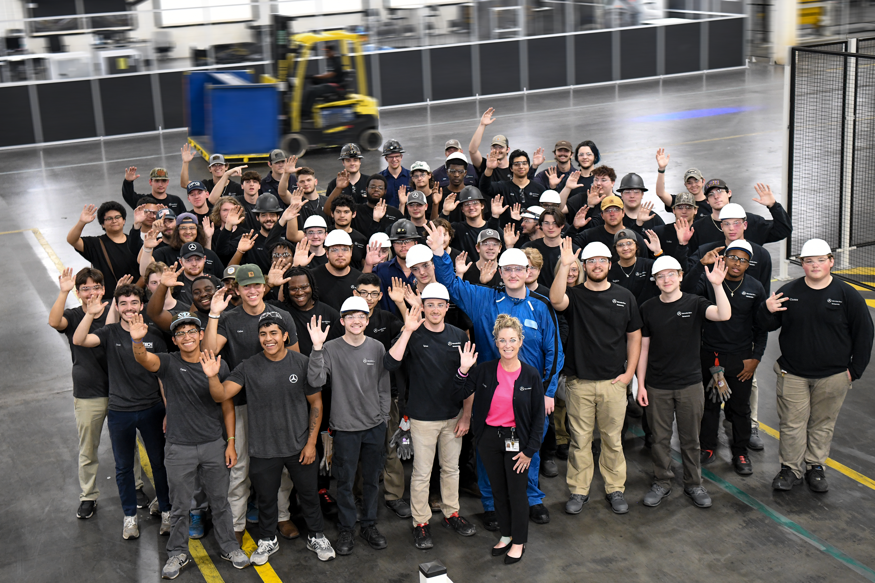 Group of Mercedes employees waving